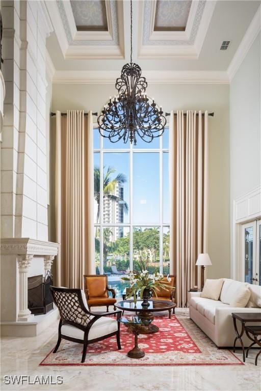 23771 Tuscany Way, Bonita Springs, FL 34134 - living area featuring a notable chandelier, visible vents, and crown molding