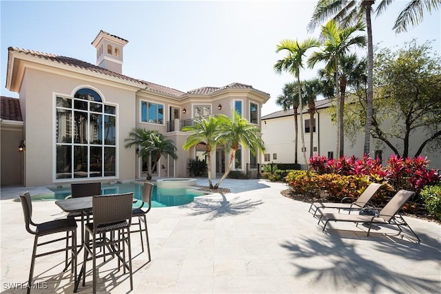 23771 Tuscany Way, Bonita Springs, FL 34134 - view of swimming pool featuring a pool with connected hot tub and a patio area