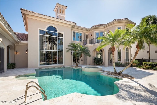 23771 Tuscany Way, Bonita Springs, FL 34134 - exterior space featuring a tile roof, a balcony, stucco siding, and a patio