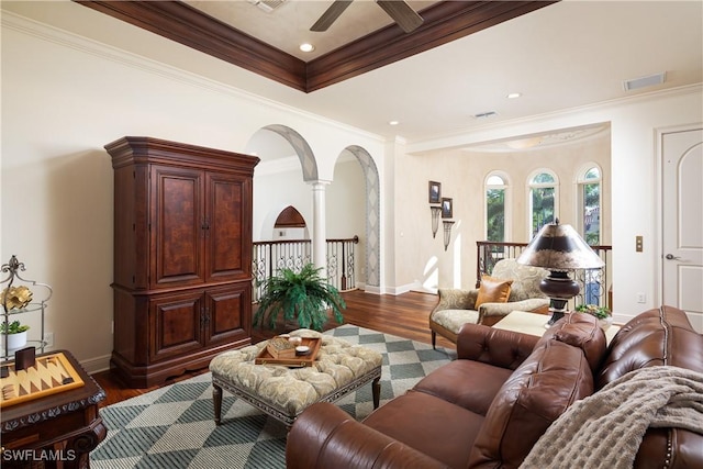 23771 Tuscany Way, Bonita Springs, FL 34134 - living area featuring crown molding, dark wood finished floors, arched walkways, visible vents, and a ceiling fan