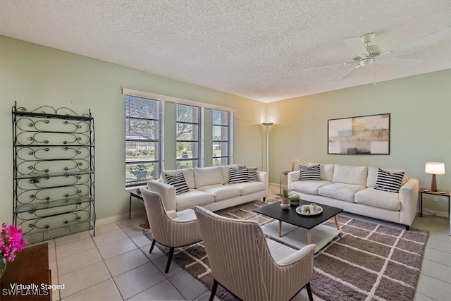 2220 SE 2nd Ter, Cape Coral, FL 33990 - living room featuring light tile patterned floors, a textured ceiling, a ceiling fan, and baseboards