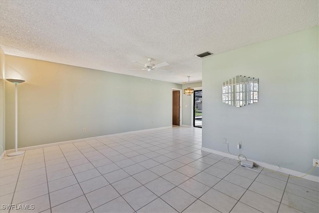 2220 SE 2nd Ter, Cape Coral, FL 33990 - empty room featuring a ceiling fan, light tile patterned floors, a textured ceiling, a chandelier, and baseboards