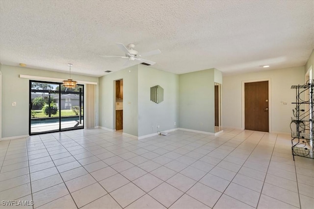 2220 SE 2nd Ter, Cape Coral, FL 33990 - unfurnished room with a ceiling fan, a textured ceiling, light tile patterned floors, and baseboards