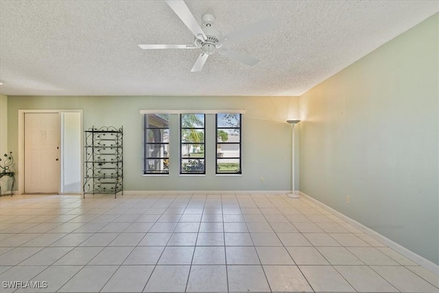2220 SE 2nd Ter, Cape Coral, FL 33990 - empty room featuring a textured ceiling, ceiling fan, and light tile patterned floors