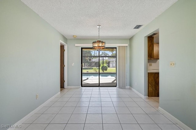 2220 SE 2nd Ter, Cape Coral, FL 33990 - unfurnished dining area with a textured ceiling, light tile patterned floors, and baseboards