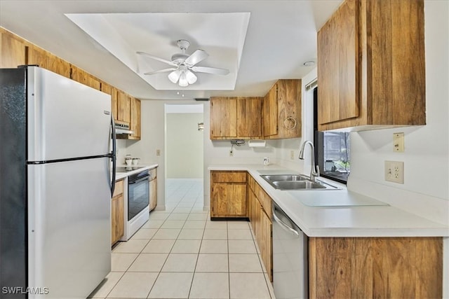 2220 SE 2nd Ter, Cape Coral, FL 33990 - kitchen featuring appliances with stainless steel finishes, a sink, a ceiling fan, brown cabinets, and light tile patterned floors