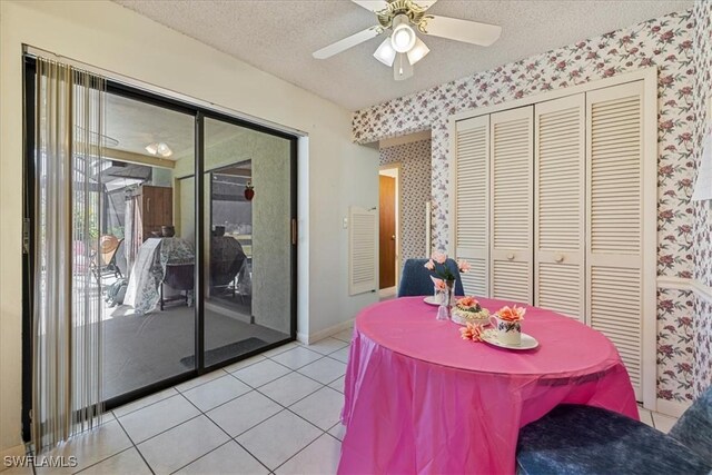 2220 SE 2nd Ter, Cape Coral, FL 33990 - dining space with wallpapered walls, a textured ceiling, light tile patterned floors, and a ceiling fan