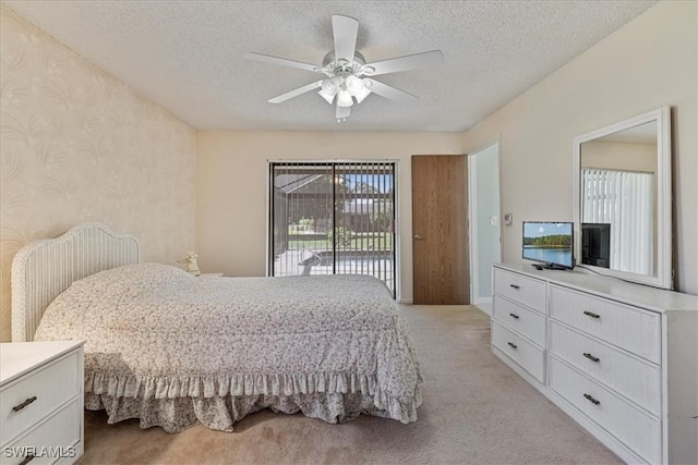 2220 SE 2nd Ter, Cape Coral, FL 33990 - bedroom featuring access to exterior, light colored carpet, a textured ceiling, ceiling fan, and wallpapered walls