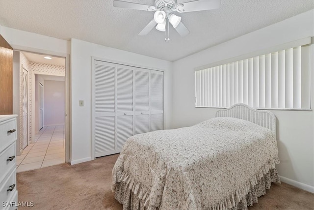 2220 SE 2nd Ter, Cape Coral, FL 33990 - bedroom with light colored carpet, a closet, baseboards, a ceiling fan, and a textured ceiling