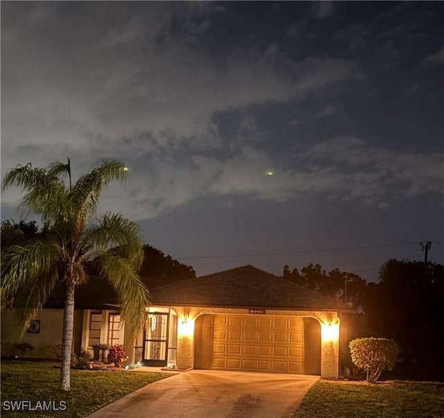 2220 SE 2nd Ter, Cape Coral, FL 33990 - view of front of property featuring driveway, an attached garage, and stucco siding