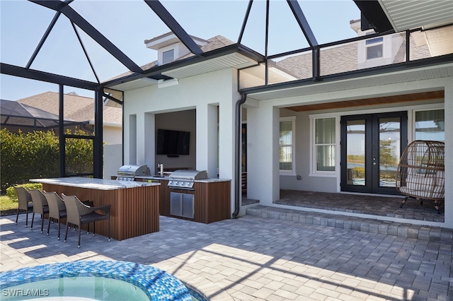 42207 Lake Timber Dr, Punta Gorda, FL 33982 - view of patio with outdoor wet bar, a grill, exterior kitchen, and french doors