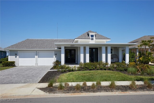 42207 Lake Timber Dr, Punta Gorda, FL 33982 - view of front of home with a garage, decorative driveway, and roof with shingles
