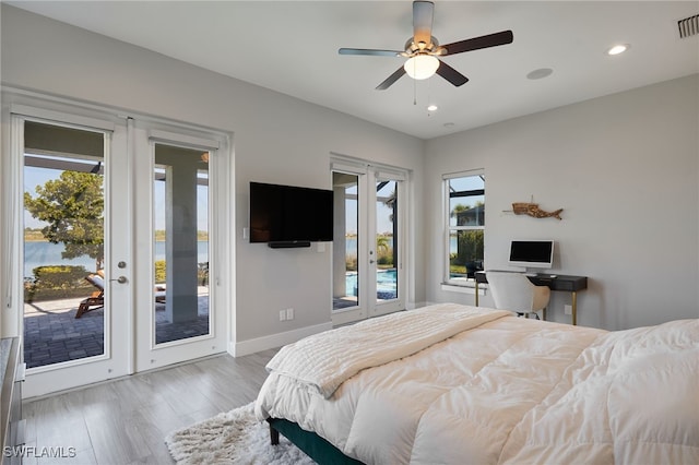 42207 Lake Timber Dr, Punta Gorda, FL 33982 - bedroom featuring wood finished floors, french doors, multiple windows, and access to exterior