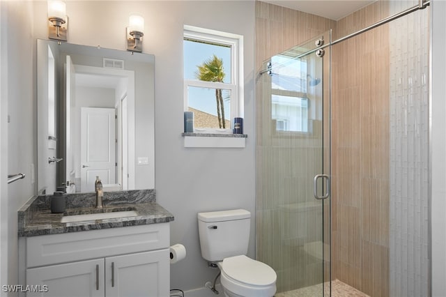 42207 Lake Timber Dr, Punta Gorda, FL 33982 - full bath with visible vents, toilet, a stall shower, and vanity