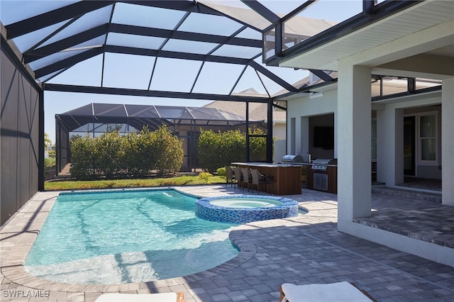 42207 Lake Timber Dr, Punta Gorda, FL 33982 - view of swimming pool featuring glass enclosure, exterior kitchen, a pool with connected hot tub, grilling area, and a patio area