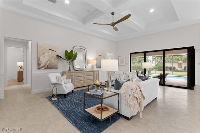 living area featuring a towering ceiling, a ceiling fan, tile patterned flooring, coffered ceiling, and beam ceiling