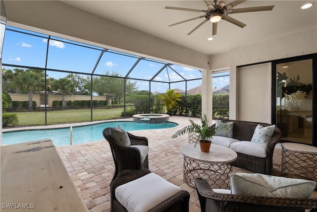 view of pool featuring an outdoor living space, a pool with connected hot tub, a ceiling fan, glass enclosure, and a patio area
