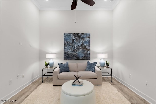 living area with crown molding, baseboards, a ceiling fan, and wood finished floors