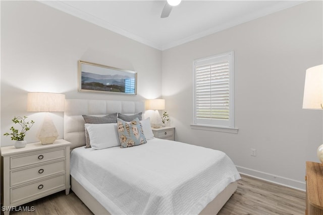 bedroom with baseboards, ornamental molding, a ceiling fan, and wood finished floors
