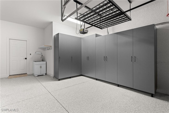 garage featuring a garage door opener and baseboards