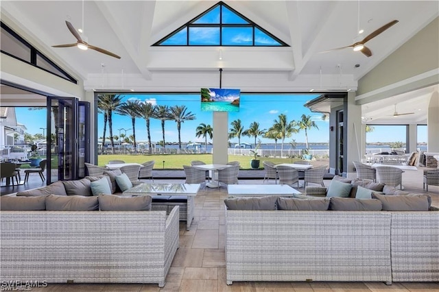 interior space with high vaulted ceiling and a ceiling fan