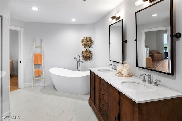 4141 Bay Beach Ln Unit 475, Fort Myers Beach, FL 33931 - bathroom with recessed lighting, a freestanding bath, a sink, and double vanity