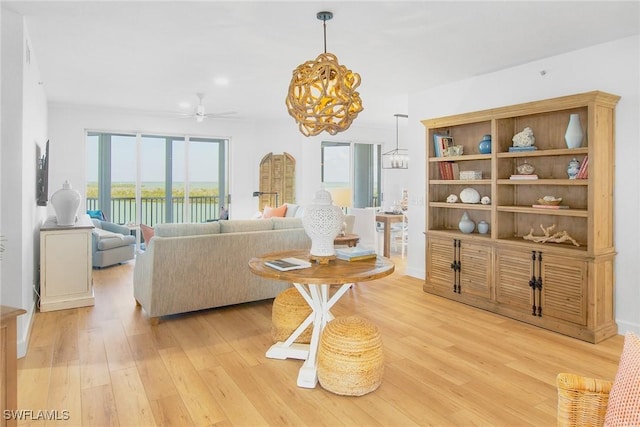 4141 Bay Beach Ln Unit 475, Fort Myers Beach, FL 33931 - living room with light wood-style flooring and ceiling fan with notable chandelier