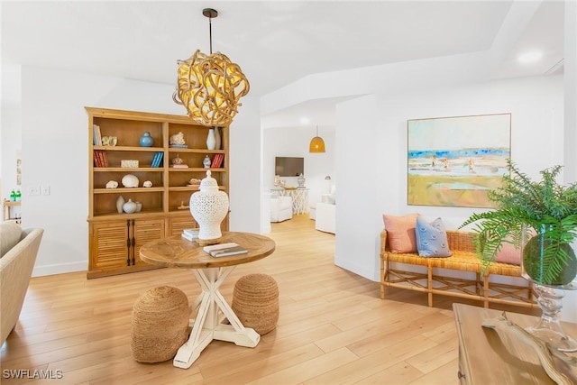 4141 Bay Beach Ln Unit 475, Fort Myers Beach, FL 33931 - living area with light wood-type flooring, baseboards, and a notable chandelier