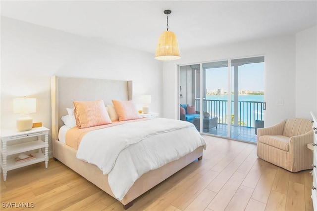 4141 Bay Beach Ln Unit 475, Fort Myers Beach, FL 33931 - bedroom with light wood-style flooring and access to exterior