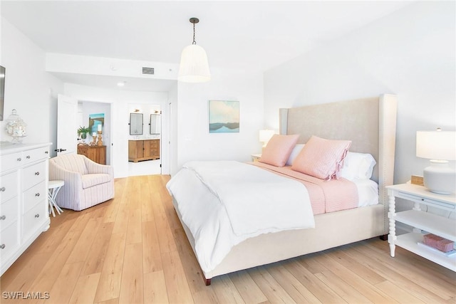 4141 Bay Beach Ln Unit 475, Fort Myers Beach, FL 33931 - bedroom featuring ensuite bath, light wood-style floors, and visible vents