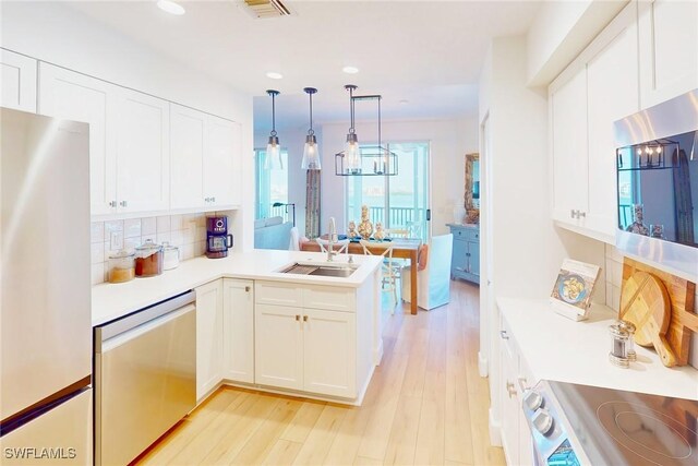 4141 Bay Beach Ln Unit 475, Fort Myers Beach, FL 33931 - kitchen with backsplash, recessed lighting, appliances with stainless steel finishes, and a sink