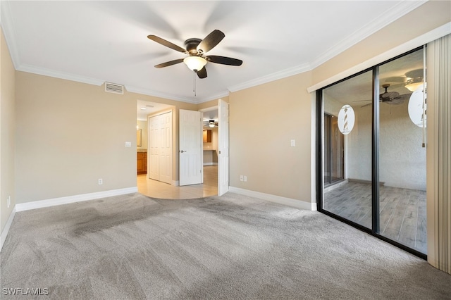 912 SW 48th Ter Unit 108, Cape Coral, FL 33914 - unfurnished bedroom with light colored carpet, baseboards, ornamental molding, ceiling fan, and a closet