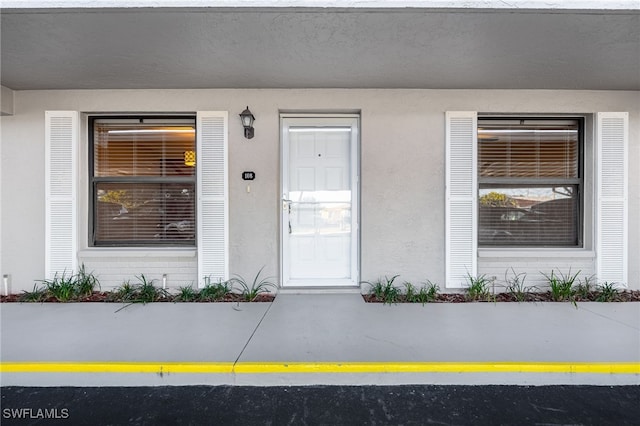 912 SW 48th Ter Unit 108, Cape Coral, FL 33914 - doorway to property with stucco siding