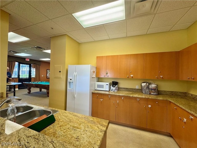 8550 Kingbird Loop Unit 638, Estero, FL 33967 - kitchen featuring white appliances, pool table, a paneled ceiling, and brown cabinets