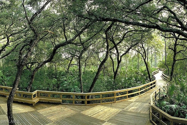 10530 Amiata Way Unit 105, Fort Myers, FL 33913 - view of home's community with a wooded view and a wooden deck