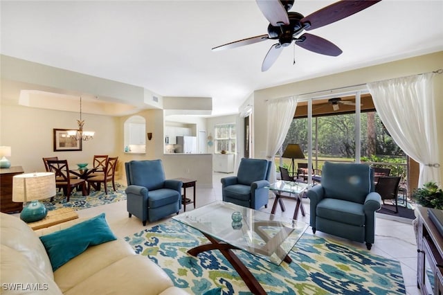 10530 Amiata Way Unit 105, Fort Myers, FL 33913 - tiled living room with arched walkways, visible vents, and ceiling fan with notable chandelier