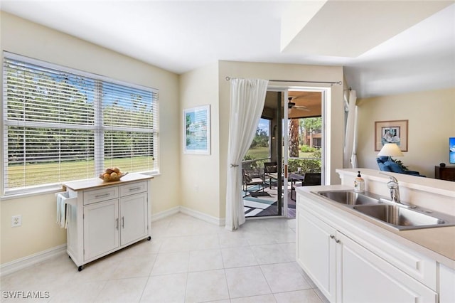 10530 Amiata Way Unit 105, Fort Myers, FL 33913 - kitchen with baseboards, a sink, light tile patterned floors, and plenty of natural light