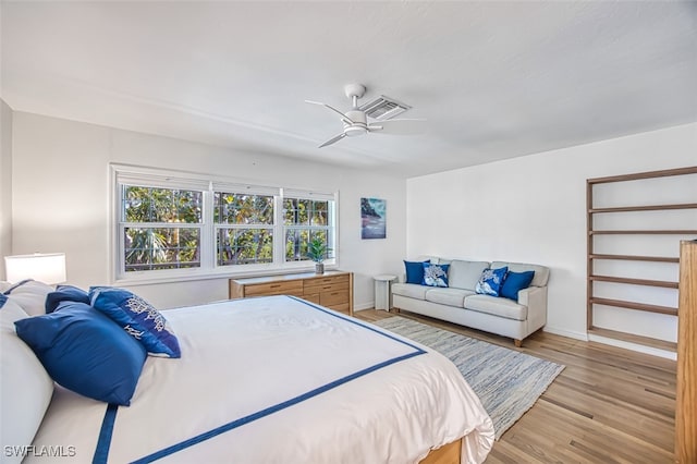 bedroom with visible vents, baseboards, light wood-style flooring, and a ceiling fan