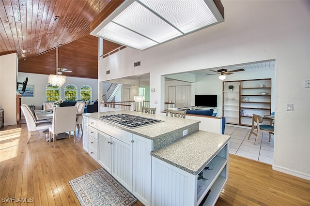 kitchen featuring open floor plan, wood ceiling, and open shelves