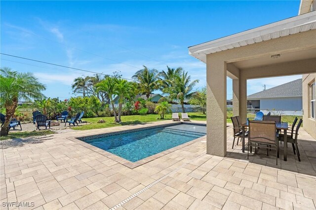 326 SW 31st St, Cape Coral, FL 33914 - outdoor pool featuring outdoor dining space and a patio area