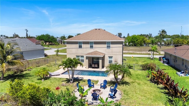 326 SW 31st St, Cape Coral, FL 33914 - back of property featuring a fire pit, stucco siding, a fenced backyard, a patio, and a lawn