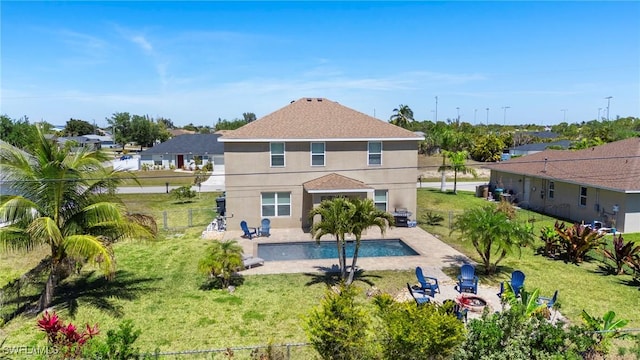 326 SW 31st St, Cape Coral, FL 33914 - rear view of house with a lawn, stucco siding, a patio area, and a fenced in pool