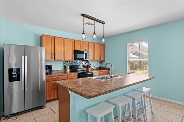 326 SW 31st St, Cape Coral, FL 33914 - kitchen featuring light tile patterned floors, a sink, dark countertops, visible vents, and black appliances