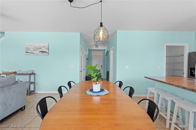 326 SW 31st St, Cape Coral, FL 33914 - dining room featuring light tile patterned floors, arched walkways, and baseboards
