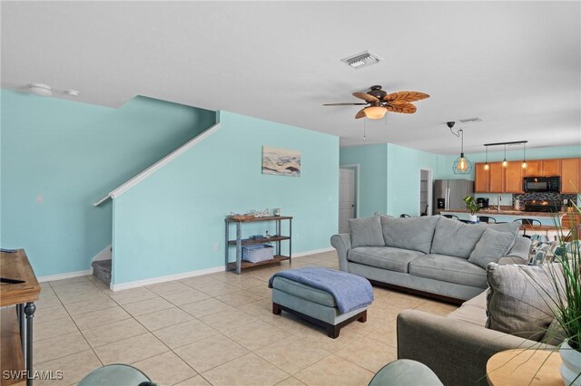326 SW 31st St, Cape Coral, FL 33914 - living area with light tile patterned floors, ceiling fan, stairs, and visible vents