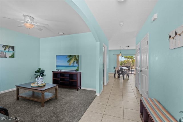 326 SW 31st St, Cape Coral, FL 33914 - living room featuring light tile patterned floors, baseboards, arched walkways, ceiling fan, and visible vents