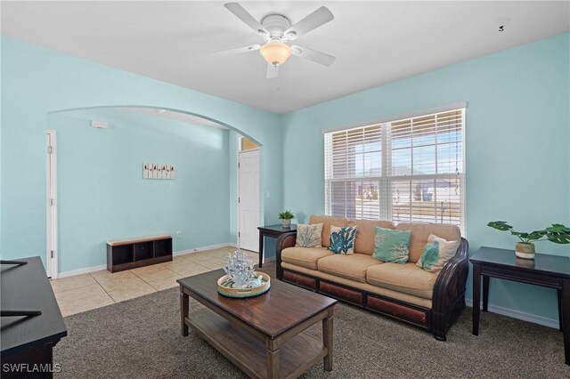 326 SW 31st St, Cape Coral, FL 33914 - living room featuring arched walkways, ceiling fan, baseboards, and light tile patterned flooring