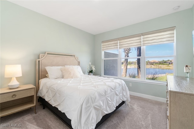 8021 Calle Canovas Ct, Naples, FL 34114 - bedroom featuring light colored carpet, a water view, and baseboards