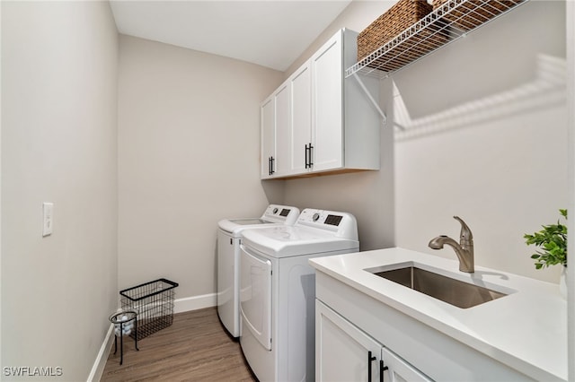 8021 Calle Canovas Ct, Naples, FL 34114 - washroom with independent washer and dryer, cabinet space, light wood-style flooring, and baseboards