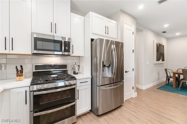 8021 Calle Canovas Ct, Naples, FL 34114 - kitchen featuring stainless steel appliances, light wood-style flooring, baseboards, light countertops, and recessed lighting
